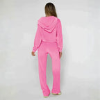 Velour tracksuit in pink shown from the back with a soft hooded jacket and relaxed pants for everyday comfort and style
