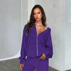 Velour tracksuit in purple close up highlighting soft velour fabric and zip hoodie detail for luxury comfort feel