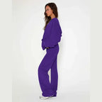 Velour tracksuit in bold purple featuring a soft hoodie and loose fit pants designed for comfort driven modern streetwear