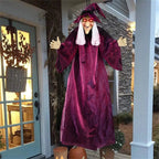 Voice-controlled Halloween witch decoration showing battery box, glowing eyes, facial details, and fabric texture.