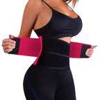 Waist trainer in black and pink design worn for fitness and waist shaping with adjustable velcro straps.