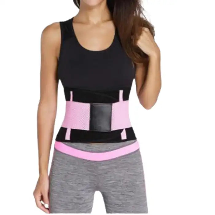 Waist trainer in light pink worn over workout clothes with adjustable black velcro front panel.