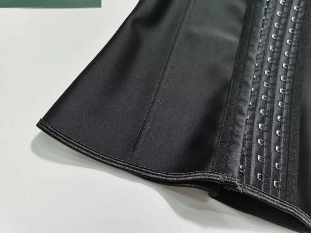 Waist trainer vest flat lay showing front hook closures and adjustable strap design for custom fit