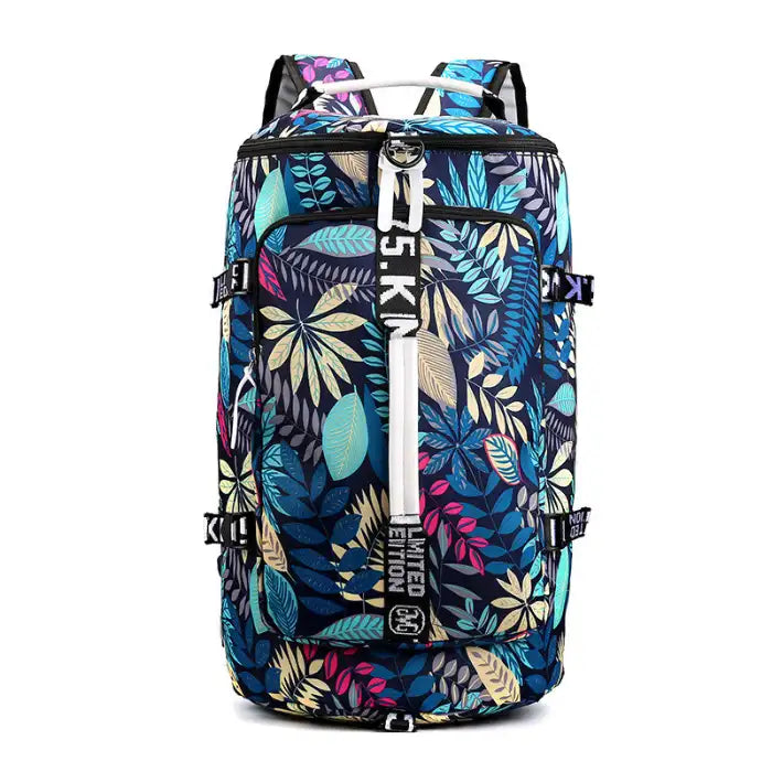 Waterproof duffle bag with colorful leaf print and multiple adjustable straps for fashion travel use.