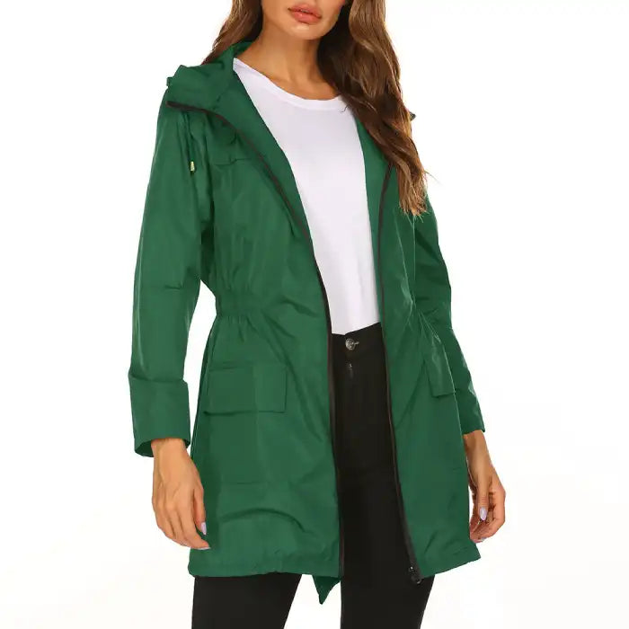 Waterproof Raincoat green lightweight women’s hooded jacket with pockets and zip closure.