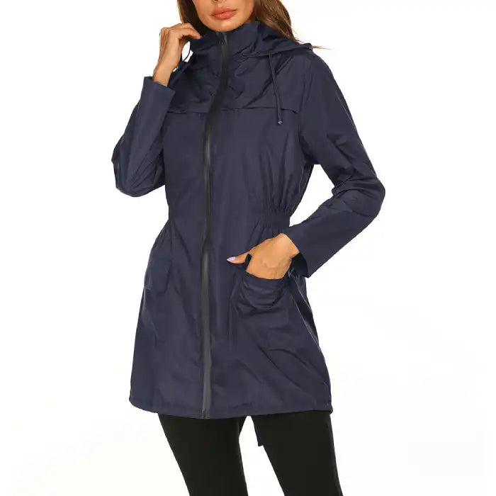 Waterproof Raincoat navy women’s windbreaker jacket featuring hood, cinched waist and front pockets.