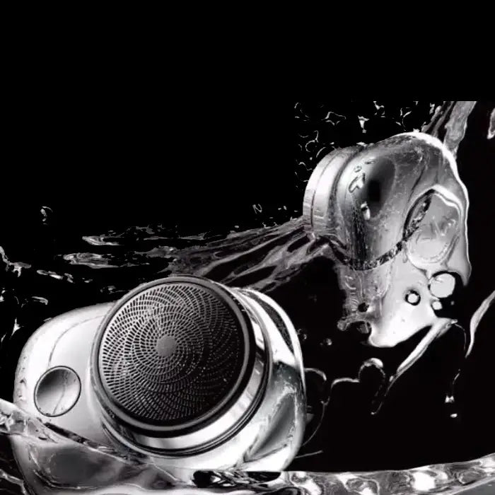 Electric shaver submerged in water with dynamic splash, demonstrating IPX7 waterproof rating in dramatic black and white image