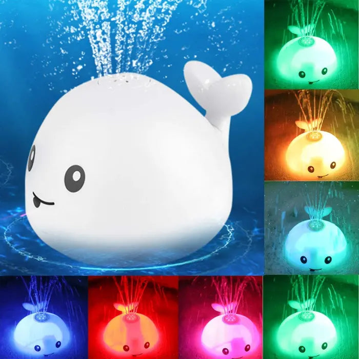 Whale bath toy spraying water with changing LED light colors in various shades.