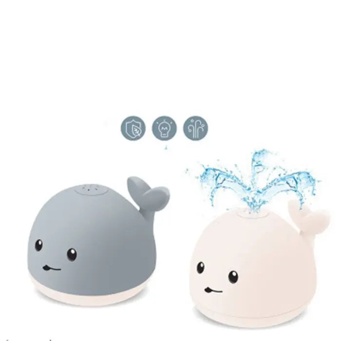 Whale bath toy in gray and white showing water spray feature with splash icons.