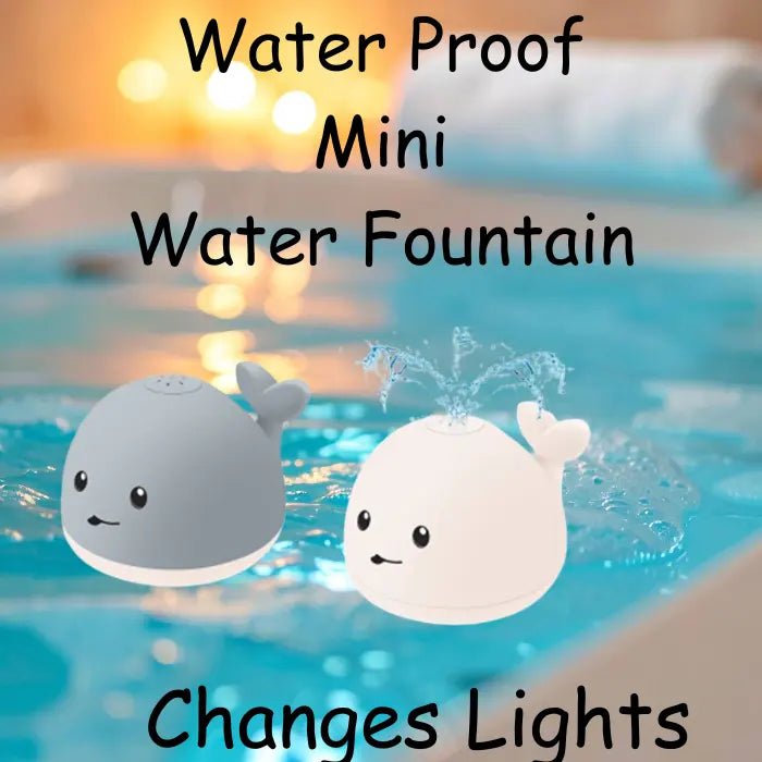 Whale bath toy with light-up water fountain feature floating in a tub.
