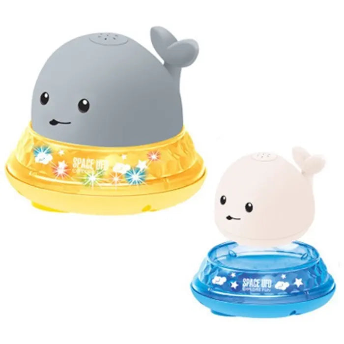 Whale bath toy set in gray and white with glowing yellow and blue bases.