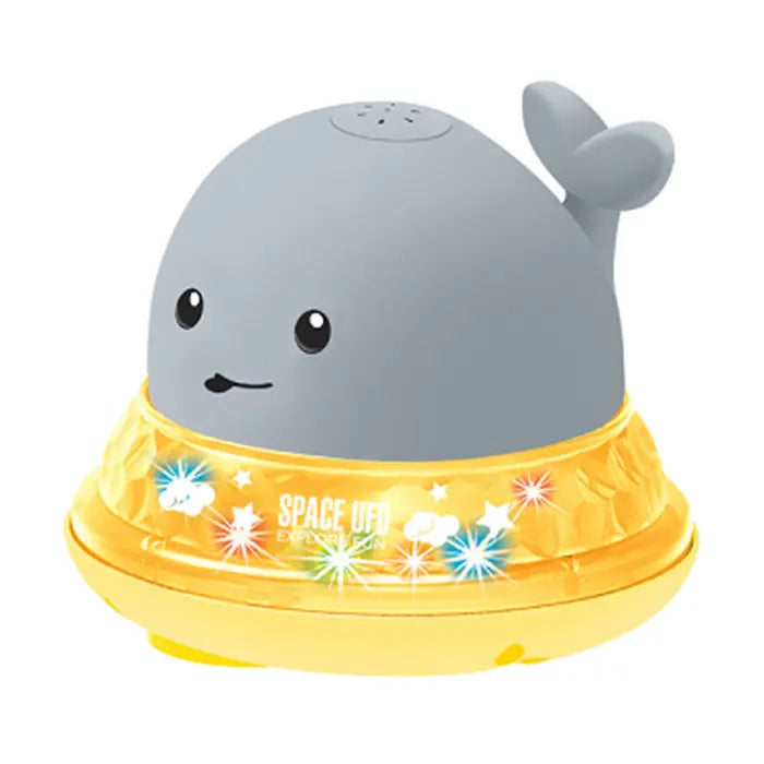 Whale bath toy with yellow UFO-style base featuring glowing LED stars and clouds.