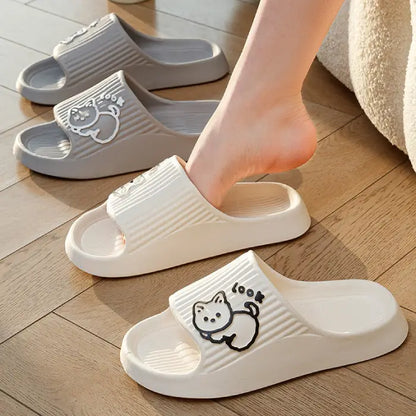  White indoor slides with cat motif shown being worn and displayed on hardwood flooring