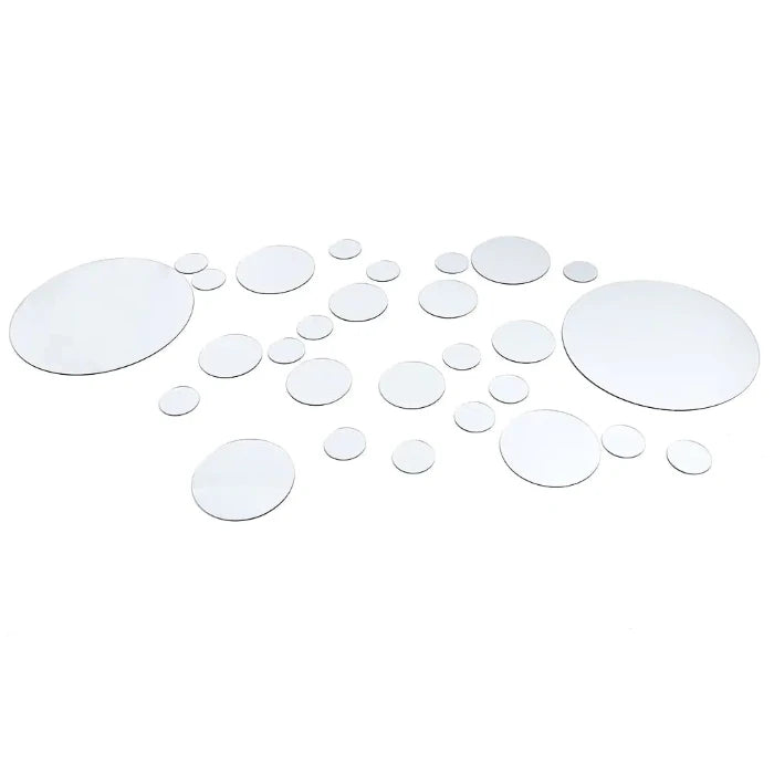 Set of round mirror stickers in various sizes arranged in a scattered pattern on a white background for wall decoration.