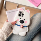 white dog phone case with pink ears, a blue collar, and a pink bell, resting on a person's lap.