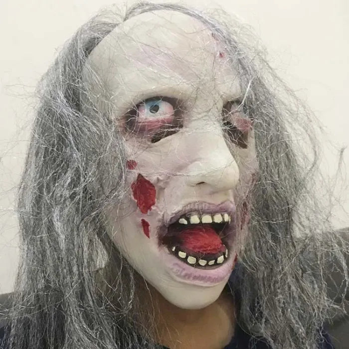 Gruesome costume mask with pale skin, sunken eyes, and bloodied open mouth.