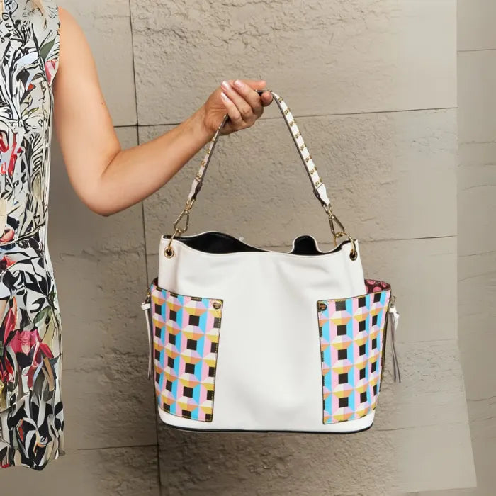 White vegan leather tote with colorful geometric panels styled for everyday wear, showing practical design