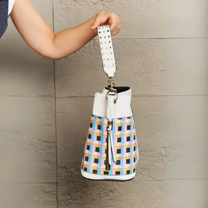 White vegan leather shoulder bag with pastel geometric side panels and studded strap, featuring 13-inch length