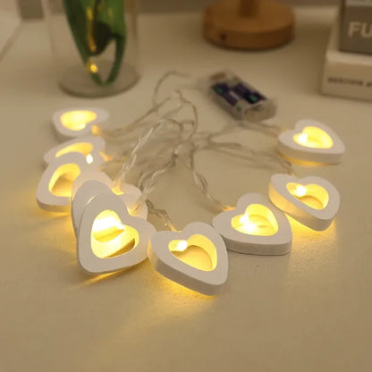 White heart string lights spread across a table, ideal for a romantic evening.