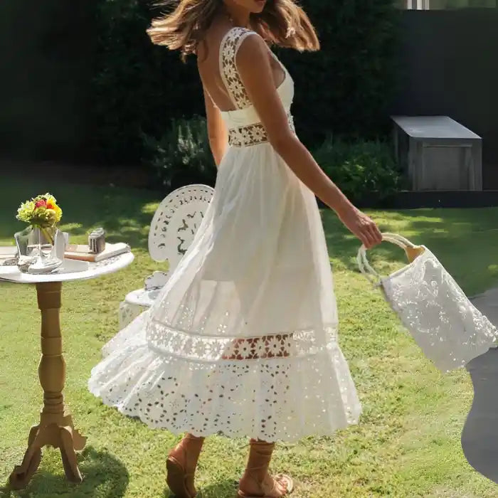 White lace midi dress with strap back detail swaying on woman walking outdoors.