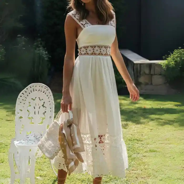 White lace midi dress featuring wide floral straps styled in garden setting