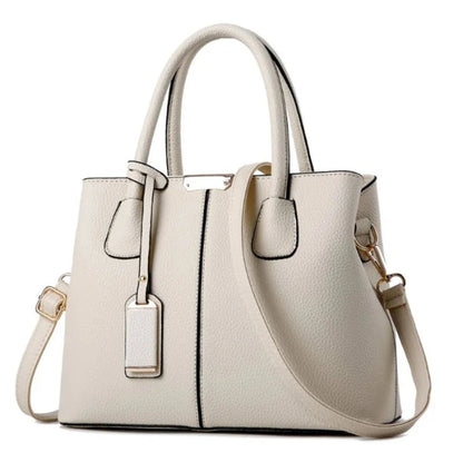 Elegant white leather handbag with gold accents and detachable strap for formal and casual occasions.