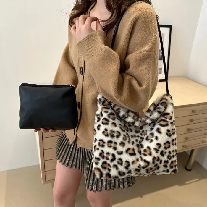 Woman carrying a white leopard print faux fur handbag with black pouch for a chic, sophisticated look.