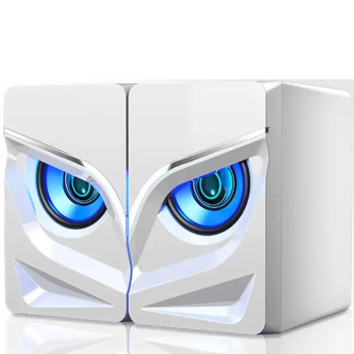 Sleek white computer speakers with blue glowing eye-like lights and angular geometric design