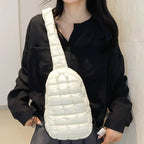 White puffer sling bag worn with black shirt, creating a striking monochrome outfit combination