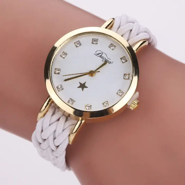 Women's watch with a gold case, white dial, and white braided rope band.