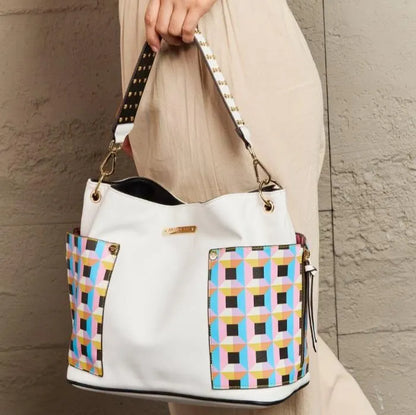 White vegan leather bag with retro geometric panels and studded strap, styled with beige outfit