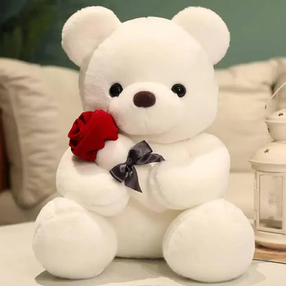 White teddy bear with red rose and gray bow, cozy home decor item.