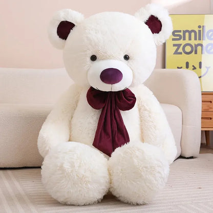 Cute large pink teddy bear with a bright bow, perfect for room decor.