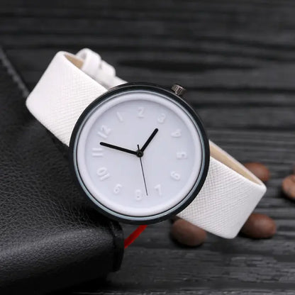 White minimalist wristwatch with an embossed dial, black hands, and a textured strap for elegant style.