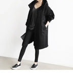Windbreaker Trench Coat in black paired with black outfit and slip-on shoes for a minimal look.