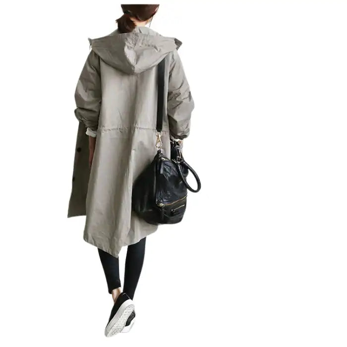 Windbreaker Trench Coat in gray shown from the back paired with black leggings and handbag
