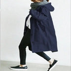 Windbreaker Trench Coat in navy blue shown in walking pose with white top and scarf.