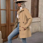 winter-belted-peacoat beige coat styled with jeans and hat as woman walks outdoors