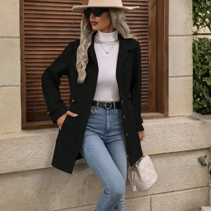 winter-belted-peacoat black coat paired with jeans and hat in a modern streetwear outfit