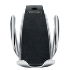 Wireless car phone holder with black leather surface and chrome automatic grip arms.