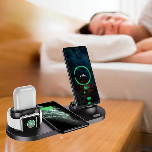 Wireless fast charging station in black charging phone, smartwatch, and AirPods on nightstand