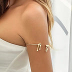women featuring gold drip style arm bracelet on upper arm