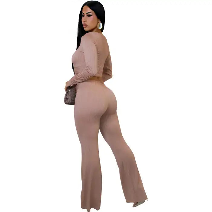 women two piece set beige ribbed knit from back view with high waist wide leg pants and fitted long sleeve crop top.