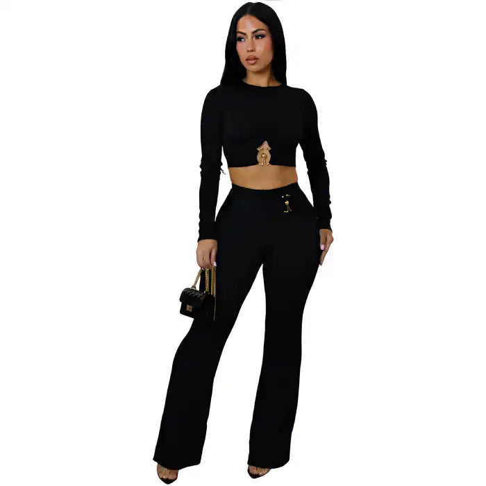 women two piece set black ribbed long sleeve crop top with ring detail and high waist wide leg pants styled for night.