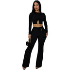 women two piece set black ribbed long sleeve crop top with ring detail and high waist wide leg pants styled for night.