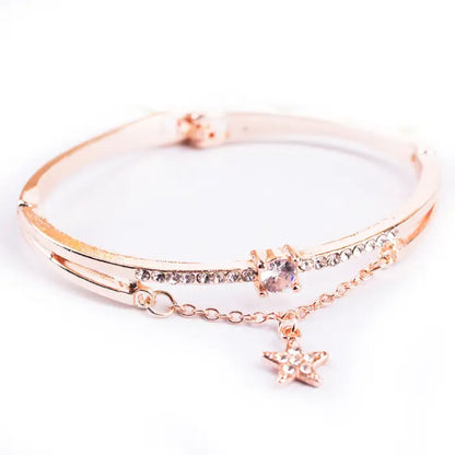 Rose gold bracelet with star charm and crystal accents from a women's set.