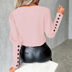 womens contrast v neck long sleeve blouse black trim back view in pink featuring button sleeve details for a soft elegant wardrobe look