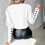 womens contrast v neck long sleeve blouse black trim shown from the back in white highlighting sleeve button accents and smooth design