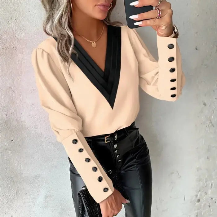 womens contrast v neck long sleeve blouse black trim in beige paired with black pants creating a polished refined and stylish outfit look