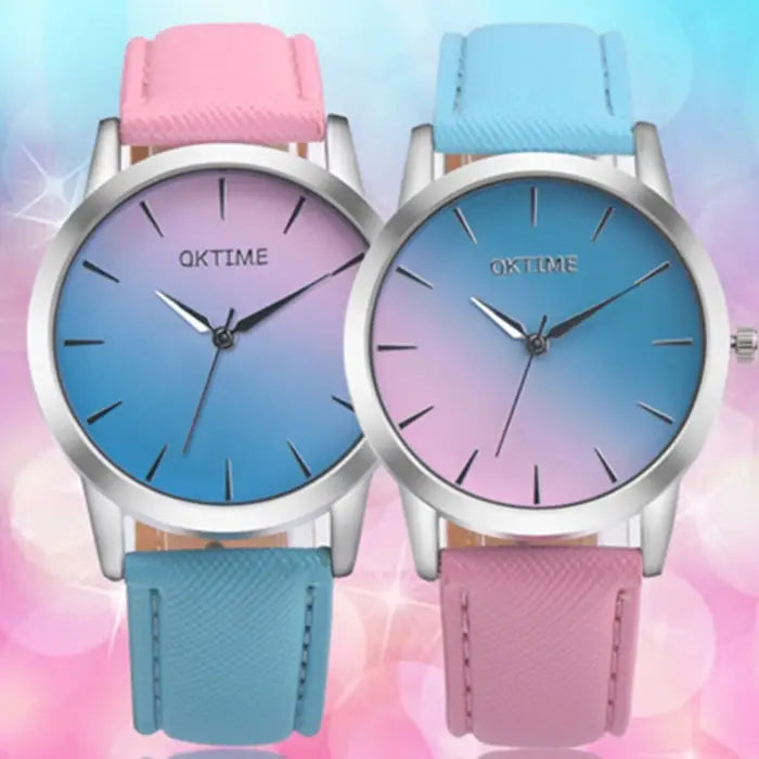 Two matching women's watches with gradient dials in pink and blue combinations, silver cases, and coordinating leather bands